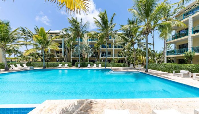 Resort pool with palm trees and balconies