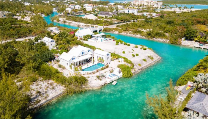 Aerial view of turquoise water and houses.