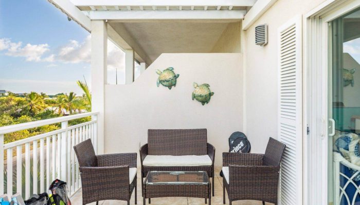 Outdoor patio with wicker furniture set.