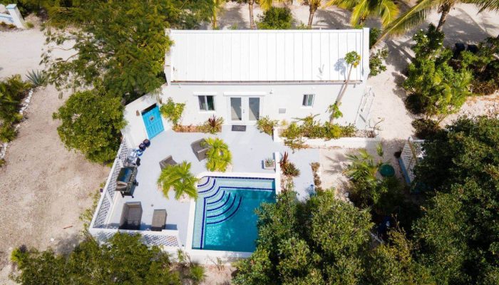 Aerial view of house with pool.