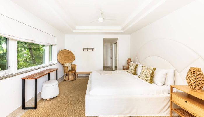 Bright minimalist bedroom with large bed.