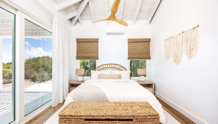 Bright bedroom with wicker and wood decor.