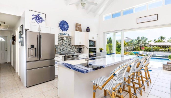 Modern kitchen with island and pool view.