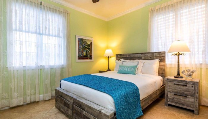 Cozy bedroom with wooden bed and lamps.