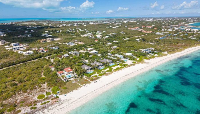 Aerial view of coastline and turquoise waters.