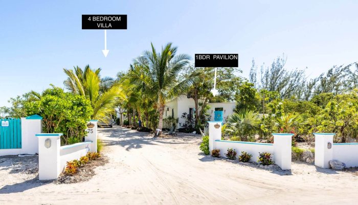 Tropical villa entrance with lush greenery.