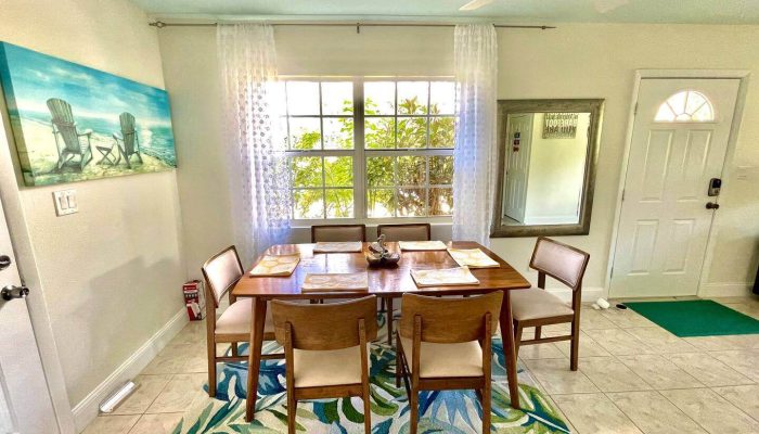 Dining room with wooden table and chairs.