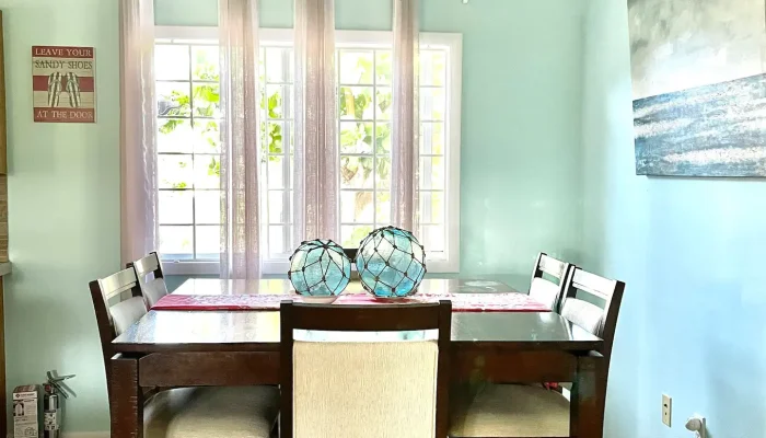 Dining room with table and ceiling fan.