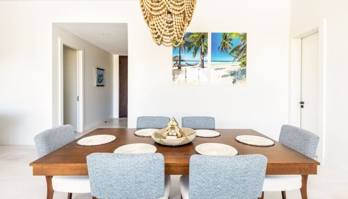 Bright coastal dining room with wooden table