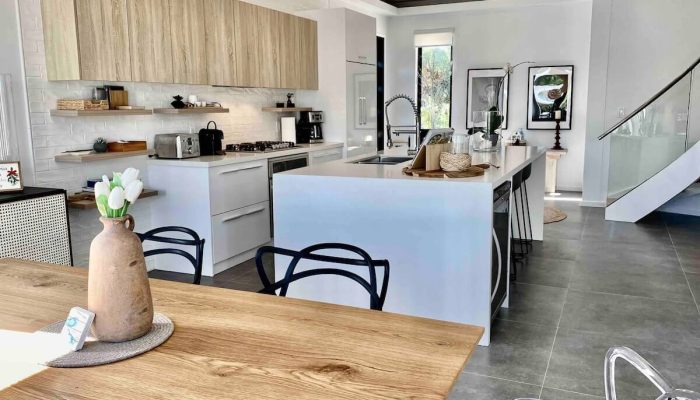 Modern open kitchen with wooden table and island