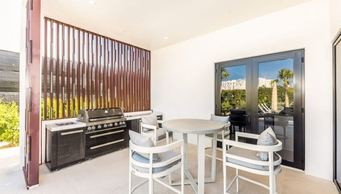 Modern outdoor patio with barbecue and seating