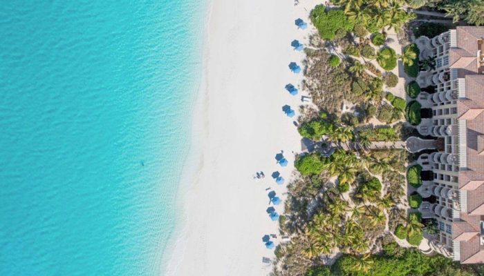 Aerial view of beach and resort buildings.