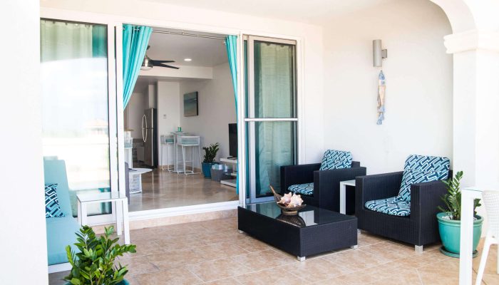 Coastal patio with wicker seating and turquoise accents