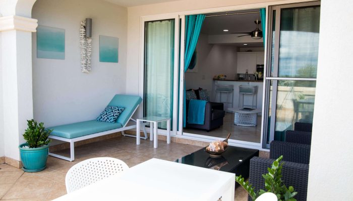 Outdoor patio with lounge chair and table.