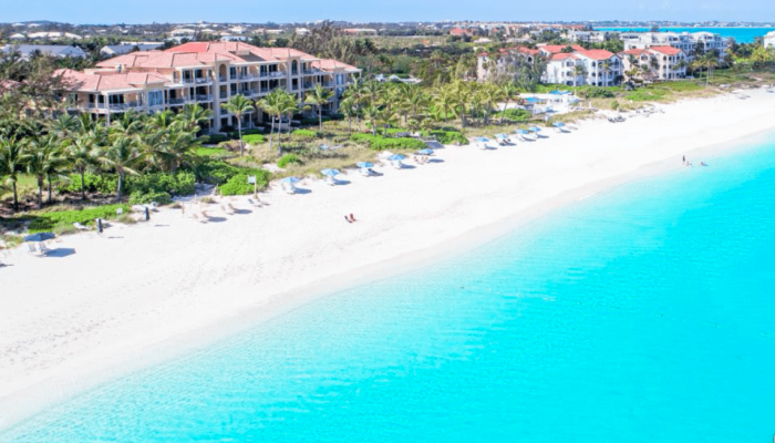 Beachfront resort with clear turquoise water.