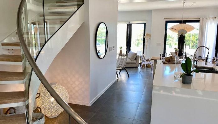 Bright modern open-plan interior with spiral staircase