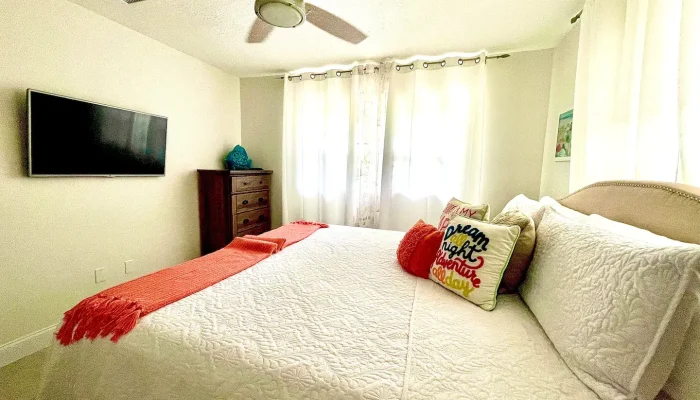 Cozy bedroom with bed and decorative pillows.